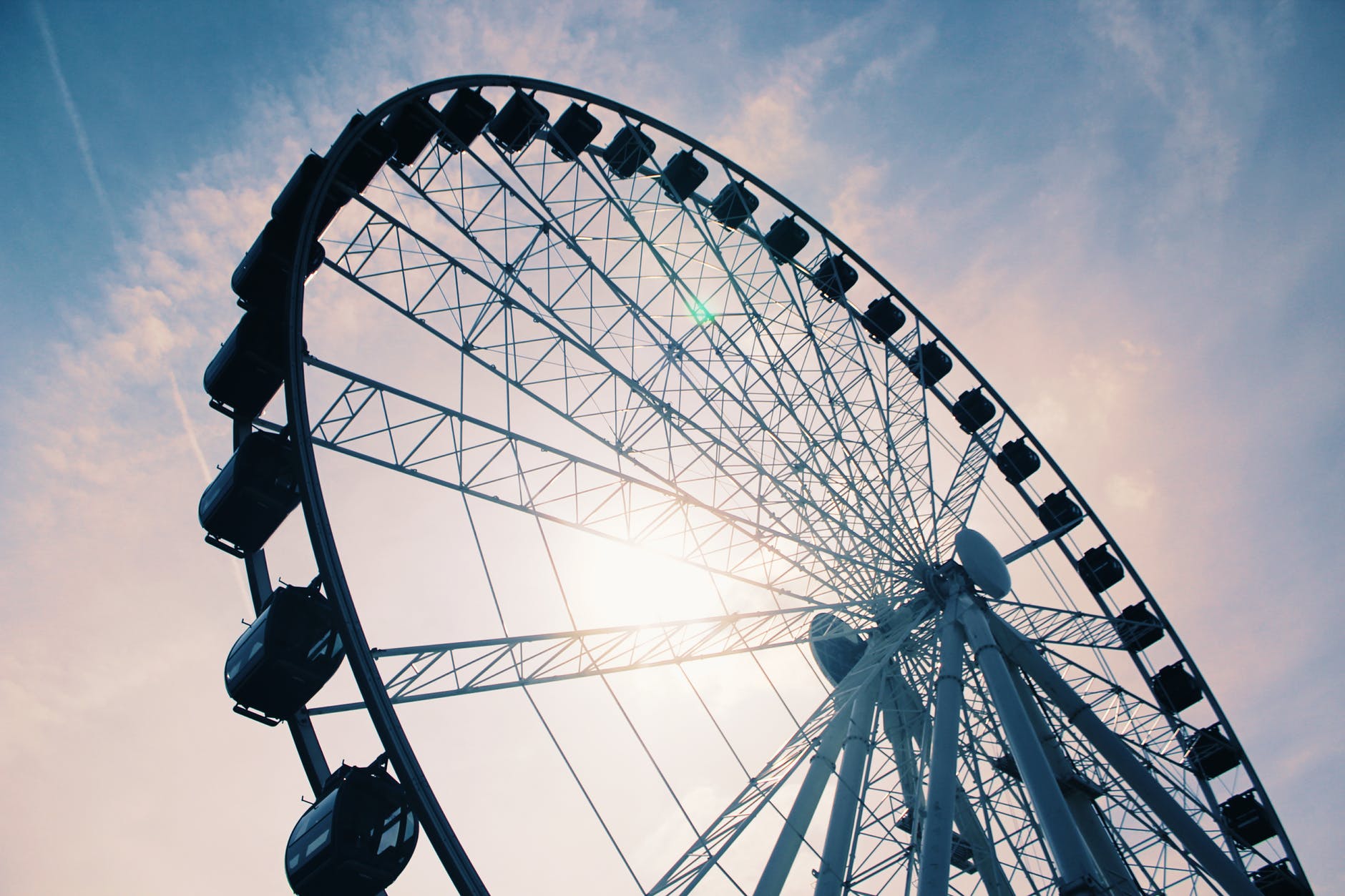 white ferris wheel under cloudy sky